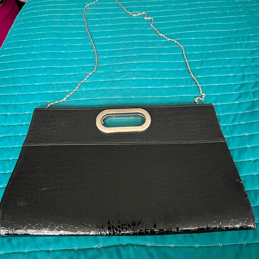 Patent leather oversized alligator texture clutch.